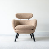 Ettore armchair upholstered in faux sheepskin fabric with modern minimalist design